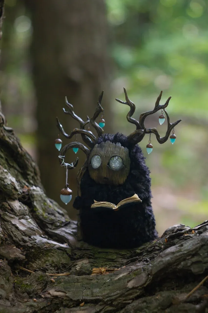 Wood Spirit Midnight Light — front view, wooden mask face with large glass eyes and teal glowing acorn lanterns