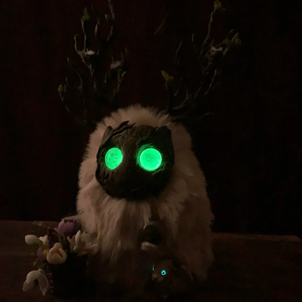 Wood Spirit Ostara's Breath in darkness — vivid green eyes glowing, the eternal light of the first spring dawn