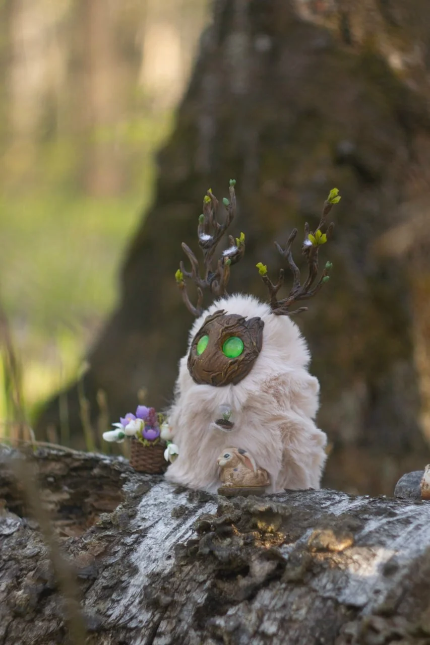Wood Spirit Ostara's Breath — side view on log, branching antlers with leaf buds and hare, handmade woodland creature sculpture for home décor